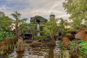 Tiana's Bayou Adventure ride at Disney World, with log flume and bayou scenery. Elite Orlando Vip Tours